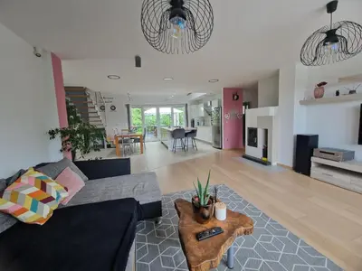 a living room with a couch and a table at Hiša Pod Gozdom in Ljubljana