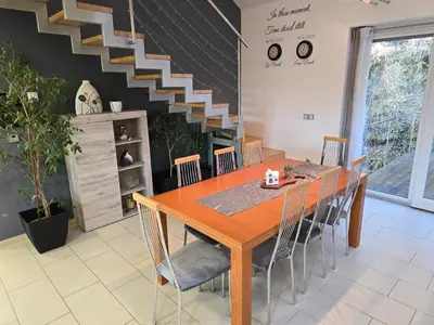 a dining room with a wooden table and chairs at Hiša Pod Gozdom in Ljubljana
