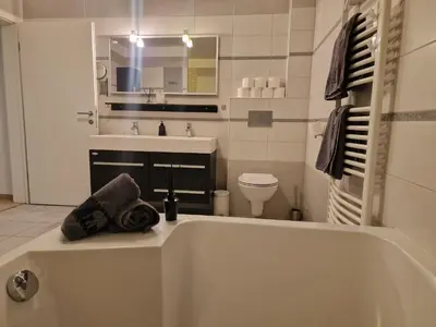 a bathroom with a tub and a sink and a toilet at Hiša Pod Gozdom in Ljubljana