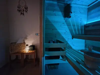 a room with a blue staircase next to a table at Hiša Pod Gozdom in Ljubljana