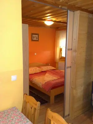 a bedroom with a bed in a small room at Apartment Beli Zajec in Mozirje