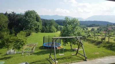 a playground in the middle of a field at Apartment Beli Zajec in Mozirje