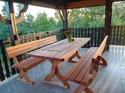 a wooden table and benches on a porch at Elton384 in Bogojina