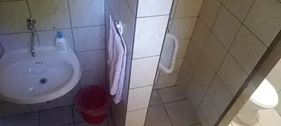 a bathroom with a sink and a trash can at Holiday Home Čumar in Cerkno