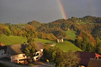 an aerial view of a house with a rainbow in the background at Apartments Lovec in Cerkno