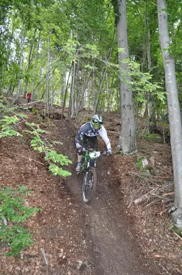 a person riding a dirt bike down a trail at Apartments Lovec in Cerkno