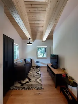 a living room with a couch and a table at Cottage at the lake in Preserje
