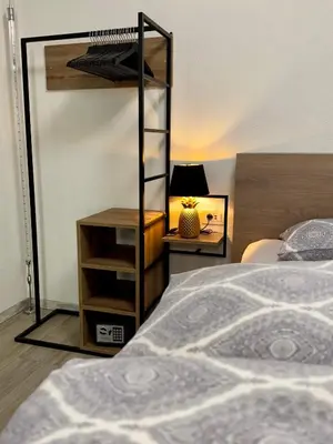a bedroom with a bunk bed and a table with a lamp at Apartments Hana Bled in Bled
