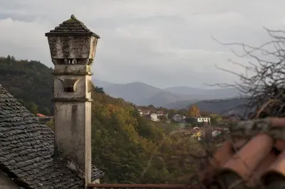 a chimney on the roof of a house with a view at Apartmaji in sobe Marija Jera Štanjel in Štanjel