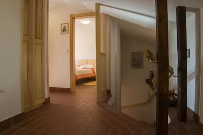 a hallway with an open door leading to a bedroom at Apartmaji in sobe Marija Jera Štanjel in Štanjel