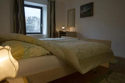 a bedroom with a bed with a window in it at Apartmaji in sobe Marija Jera Štanjel in Štanjel