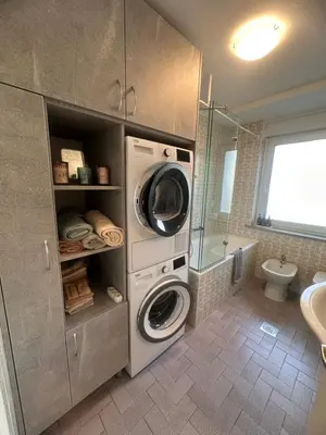 a bathroom with a washing machine and a washer at Apartment Armic in Ljubljana