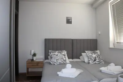 a bedroom with a bed with two towels on it at Šeherezada Rooms in Ljubljana