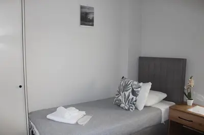 a bedroom with a bed with two towels on it at Šeherezada Rooms in Ljubljana