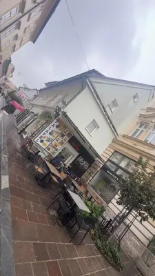 a restaurant with tables and chairs in front of a building at Šeherezada Rooms in Ljubljana