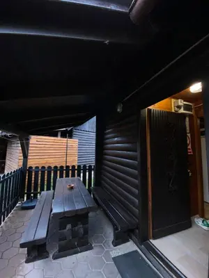 a wooden bench sitting in front of a building at Hiška Nisa in Čatež ob Savi