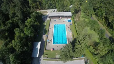 an overhead view of a swimming pool in a park at Fully equipped SIX BEDROOM HOUSE 15 kilometers from LAKE BLED - with a terrace, garden, playground, and parking in Kropa