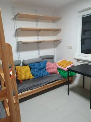 a bench with pillows on it in a room at Fully equipped SIX BEDROOM HOUSE 15 kilometers from LAKE BLED - with a terrace, garden, playground, and parking in Kropa