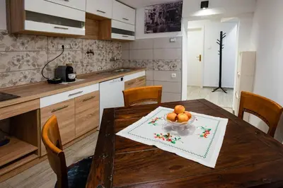 a kitchen with a wooden table with a bowl of fruit on it at Apartma Sejalec, Lesce - Bled in Lesce