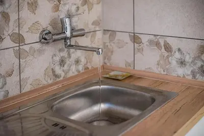 a kitchen sink with water coming from a faucet at Apartma Sejalec, Lesce - Bled in Lesce