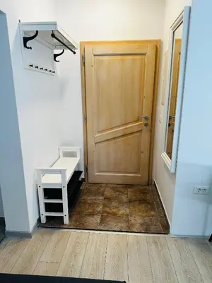 a hallway with a wooden door and a wooden floor at Apartma Medved - Pokljuka in Zgornje Gorje