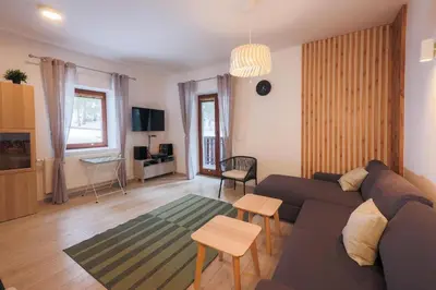 a living room with a couch and a table at Apartma Medved - Pokljuka in Zgornje Gorje