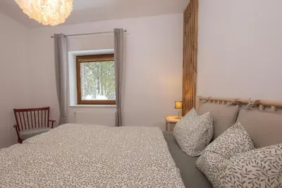 a bedroom with a bed and a window at Apartma Medved - Pokljuka in Zgornje Gorje