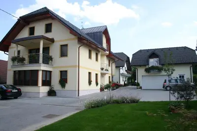 a house with a car parked in front of it at Apartment Sobe Ravbar in Novo Mesto