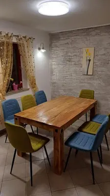 a dining room with a wooden table and chairs at Apartments Planina pod Sumikom in Planina pod Sumnikom