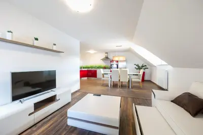 a living room with a white couch and a table at Apartments Planina pod Sumikom in Planina pod Sumnikom