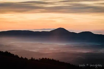a view of a mountain with a layer of fog at Apartments Planina pod Sumikom in Planina pod Sumnikom