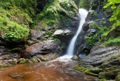 a waterfall on the side of a river at Apartments Planina pod Sumikom in Planina pod Sumnikom