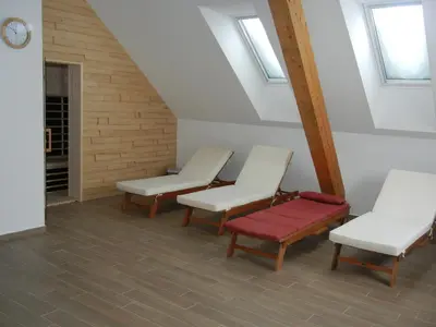 a room with three white chairs and a red bench at Guesthouse Macesen in Spodnja Sorica