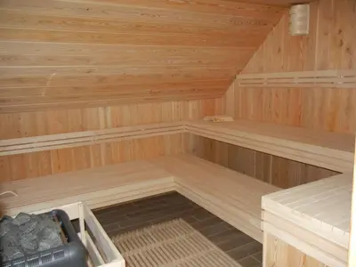 an empty sauna with wooden walls and wooden floors at Guesthouse Macesen in Spodnja Sorica