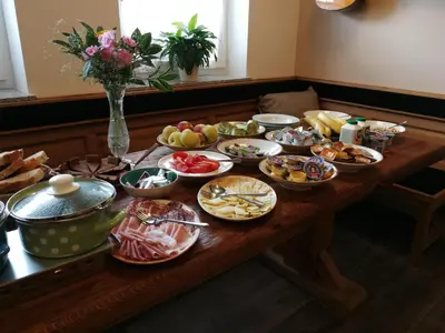 a wooden table with a bunch of food on it at Guesthouse Macesen in Spodnja Sorica