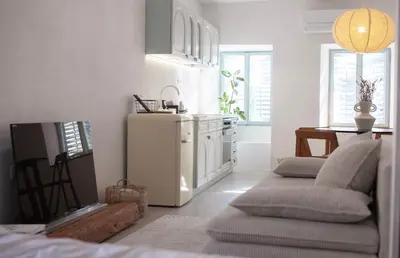 a kitchen with a couch and a white refrigerator at Apartment Sturje in Ajdovščina