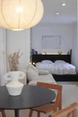 a bedroom with a bed and a table with a chair at Apartment Sturje in Ajdovščina