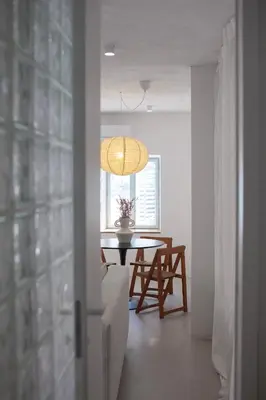 a dining room with a table and a window at Apartment Sturje in Ajdovščina