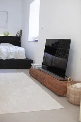 a bedroom with a bed and a flat screen tv at Apartment Sturje in Ajdovščina