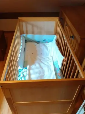 a wooden crib with a mattress in it at Holiday Home Prdelanca in Luče