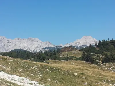 a mountain range with snow capped mountains in the background at Holiday Home Prdelanca in Luče