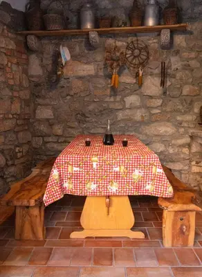 a room with a table with a red and white umbrella at PosestvoRavbar in Dutovlje