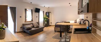 a living room with a couch and a table at PosestvoRavbar in Dutovlje