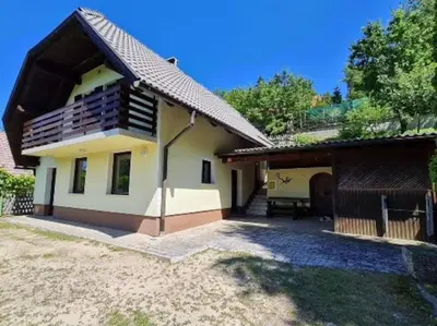 a small white house with a roof at Idyllisches Haus in der Natur in Šoštanj