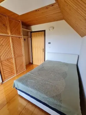 a room with a bed and a wooden floor at Idyllisches Haus in der Natur in Šoštanj