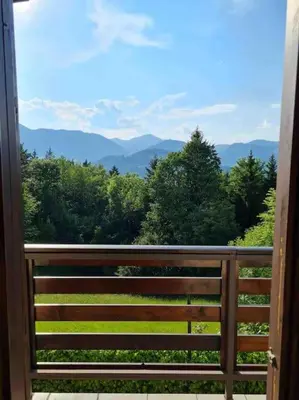 a balcony with a view of the mountains at Idyllisches Haus in der Natur in Šoštanj