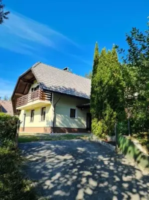 a house with a driveway in front of it at Idyllisches Haus in der Natur in Šoštanj