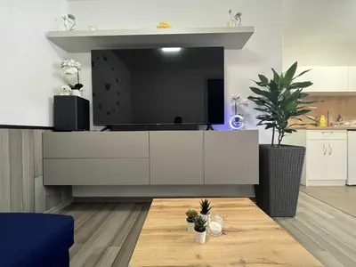 a living room with a large tv on a wall at Apartment Adam & Eva, Near terme Olimia, Free Parking in Podčetrtek
