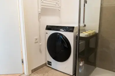 a washer and dryer in a small room at Ella's Cozy place in Ljubljana