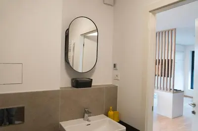 a bathroom with a sink and a mirror at Ella's Cozy place in Ljubljana